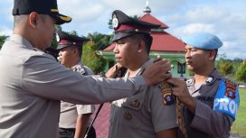 Kapolres Gumas AKBP Theodorus Priyo Santosa sedang memasangkan tanda pangkat di personil yang mengalami kenaikan pangkat digelar di Mapolres Gumas. Senin (01/07/2024).
