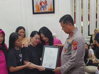 FOTO : Kapolda Kalteng saat menyerahkan piagam penghargaan kepada keluarga besar Alhamarhum Aipda Anumerta Yudhie Perdana Putra.