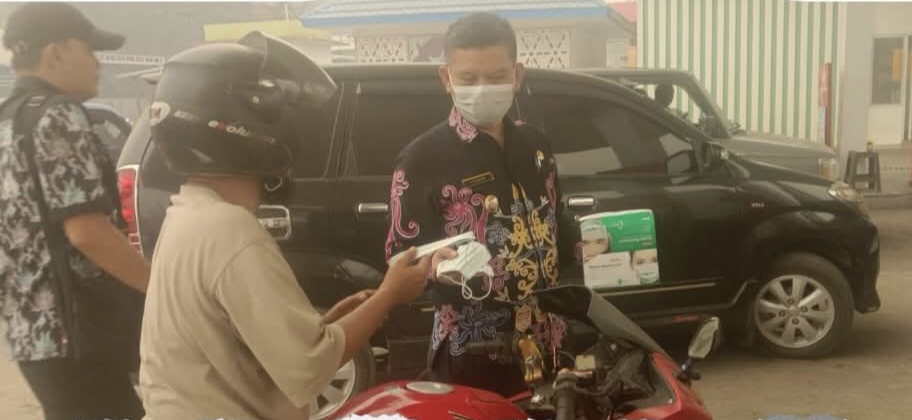 FOTO : Wabup Katingan Firdaus, saat membagikan masker kepada masyarakat di SPBU Kasongan.